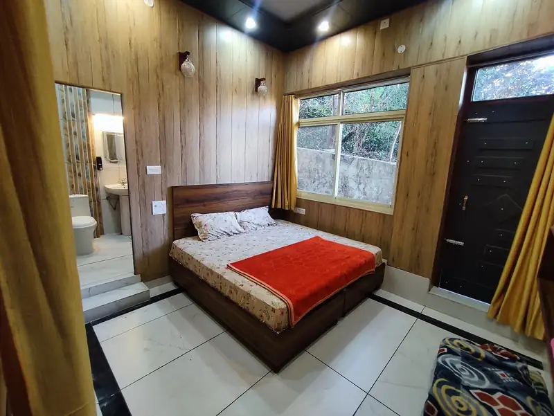 Clean comfortable rooms with attached bathrooms at Sri Yoga Ashram