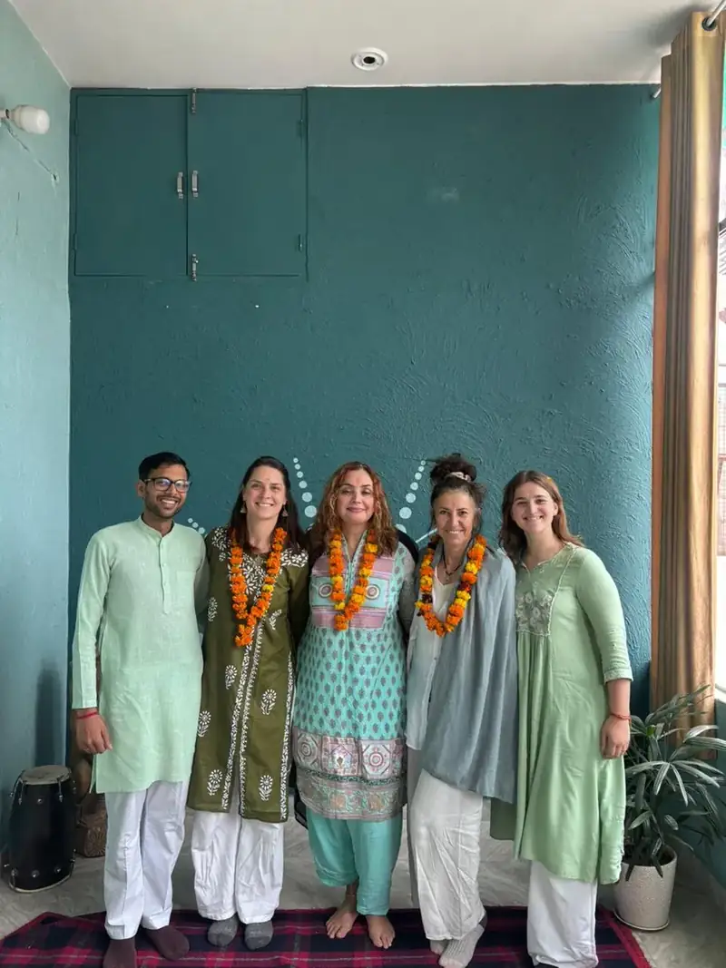 Students and teachers in traditional Indian dress with garlands at Sri Yoga Ashram, Rishikesh